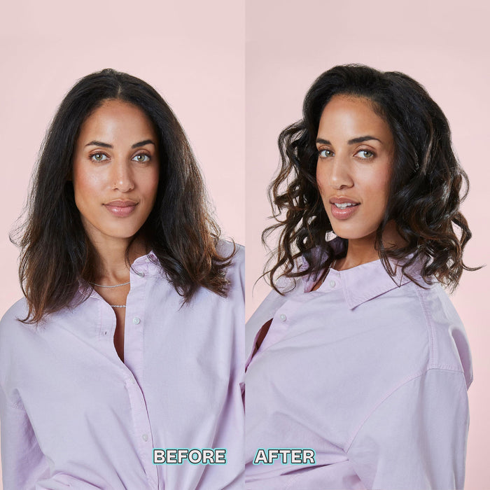 A side-by-side before and after comparison of a woman's hair, showing a straight medium-length dark brown look on the left and a wavy medium-length dark brown look on the right, both wearing a light lavender button-up shirt against a solid pale pink background.