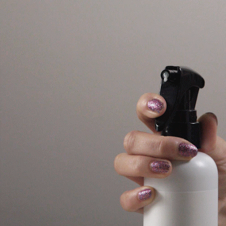 Gif showing a hand pressing on the nozzle of the Multitasking Mist