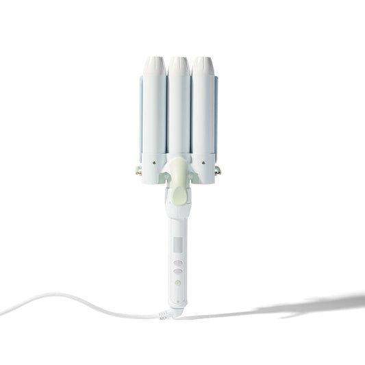 A white triple-cylinder curling iron with three curved barrels, a light green center button, and a white power cord, shown on a clean white background with a soft shadow.