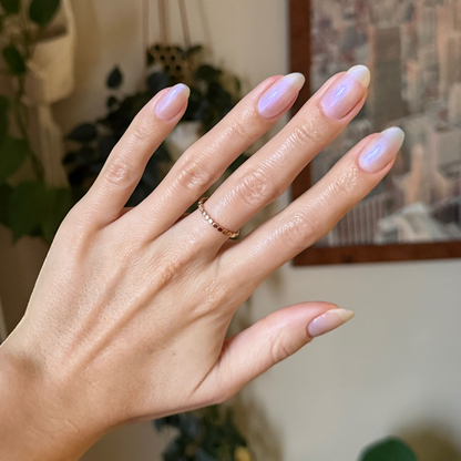 Hand showing nails with soft iridescent pearly finish using BAROQUE Gel for a subtle at-home manicure look