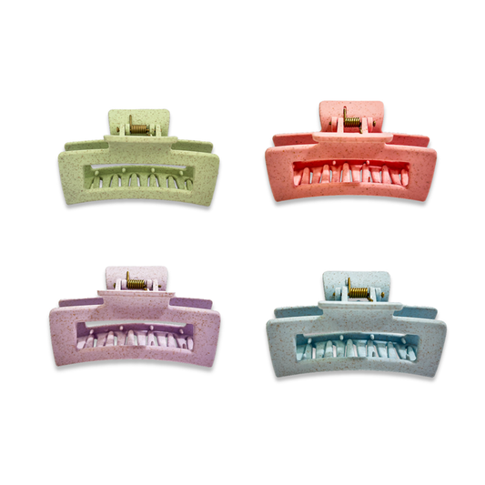Set of four colorful hair clips on a white background