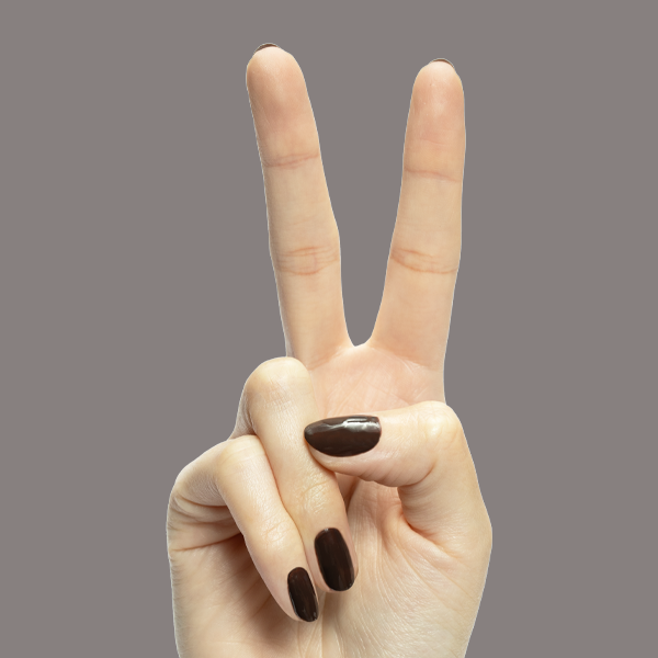 Hand showing peace sign with Dark Chocolate nail polish on medium-length nails against taupe background
