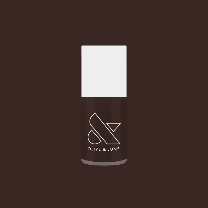 Olive and June Dark Chocolate nail polish bottle on deep brown background for rich manicure looks