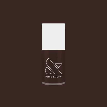 Olive and June Dark Chocolate nail polish bottle on deep brown background for rich manicure looks
