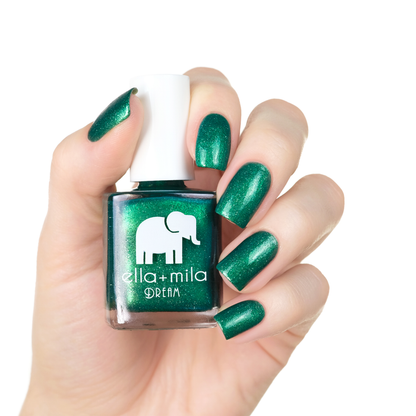Emerald Memories emerald shimmer nail polish manicure on a light skin tone with the bottle