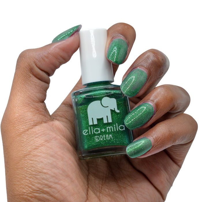 Emerald Memories emerald green nail polish on a deep skin tone, hand holding the bottle
