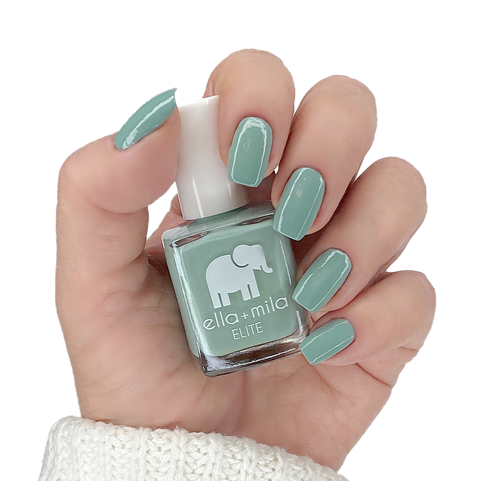First Class icy green nail polish manicure on a light skin tone with the bottle