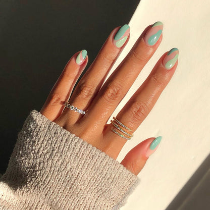 First Class muted green nail polish manicure on a medium skin tone in sunlight
