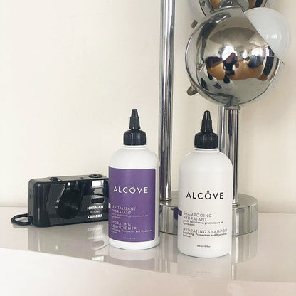 Alcove Hydrating Shampoo bottle and Conditioner bottle side-by-side