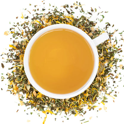 A white cup of Organic Lymphatic Cleanse tea surrounded by the loose leaf blend.