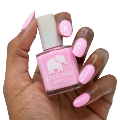 Serendipity pastel pink nail polish on a deep skin tone, hand holding the bottle