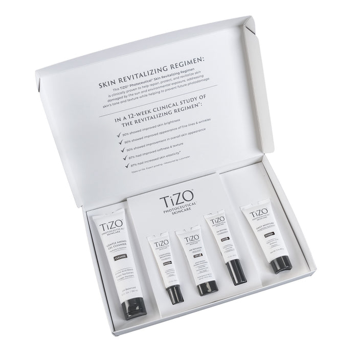 Opened TiZO Photoceutical Skincare Skin Revitalizing Regimen box, TiZO Gentle Amino Gel Cleanser tube, TiZO Complexion Brightener tube, AM Replenish Lightly Tinted tube, TiZO PM Restore tube, and TiZO Daily Moisture tube.