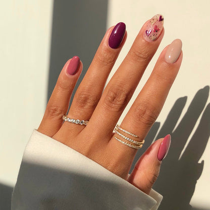 Take Off berry pink and nude mix-and-match manicure with rings in sunlight