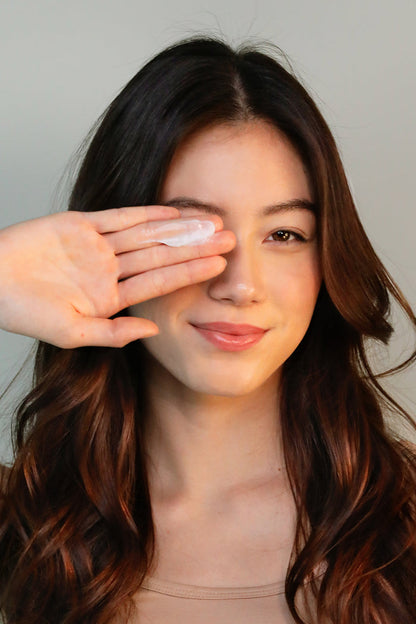 girl with goop of dry shampoo on hand smiling
