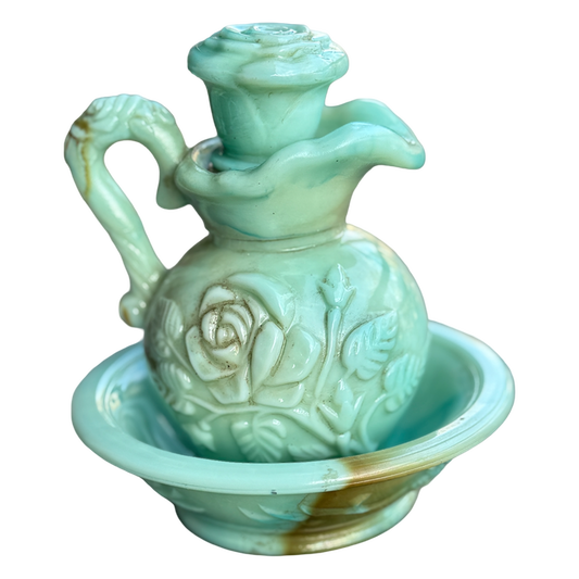 Decorative ceramic oil lamp with floral designs on a white background