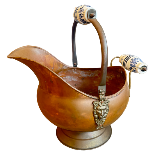Bronze pitcher with decorative handles on a white background